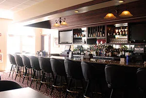 Bar stools lined up at the Mezza Luna bar