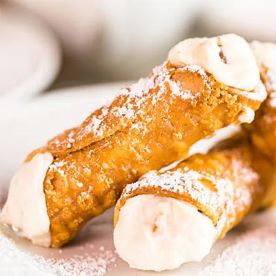 Homemade cannoli dusted with powdered sugar