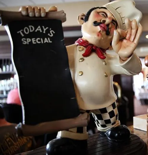 Chef figurine holding a Today&rsquo;s Special board at Mezza Luna